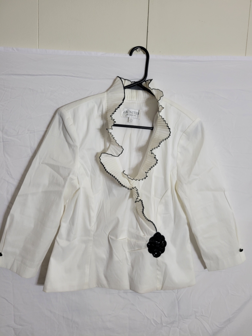 Elegant White Ruffle-Trim Jacket with Black Floral Accent